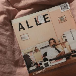 ALLE magazine on a bed sheet