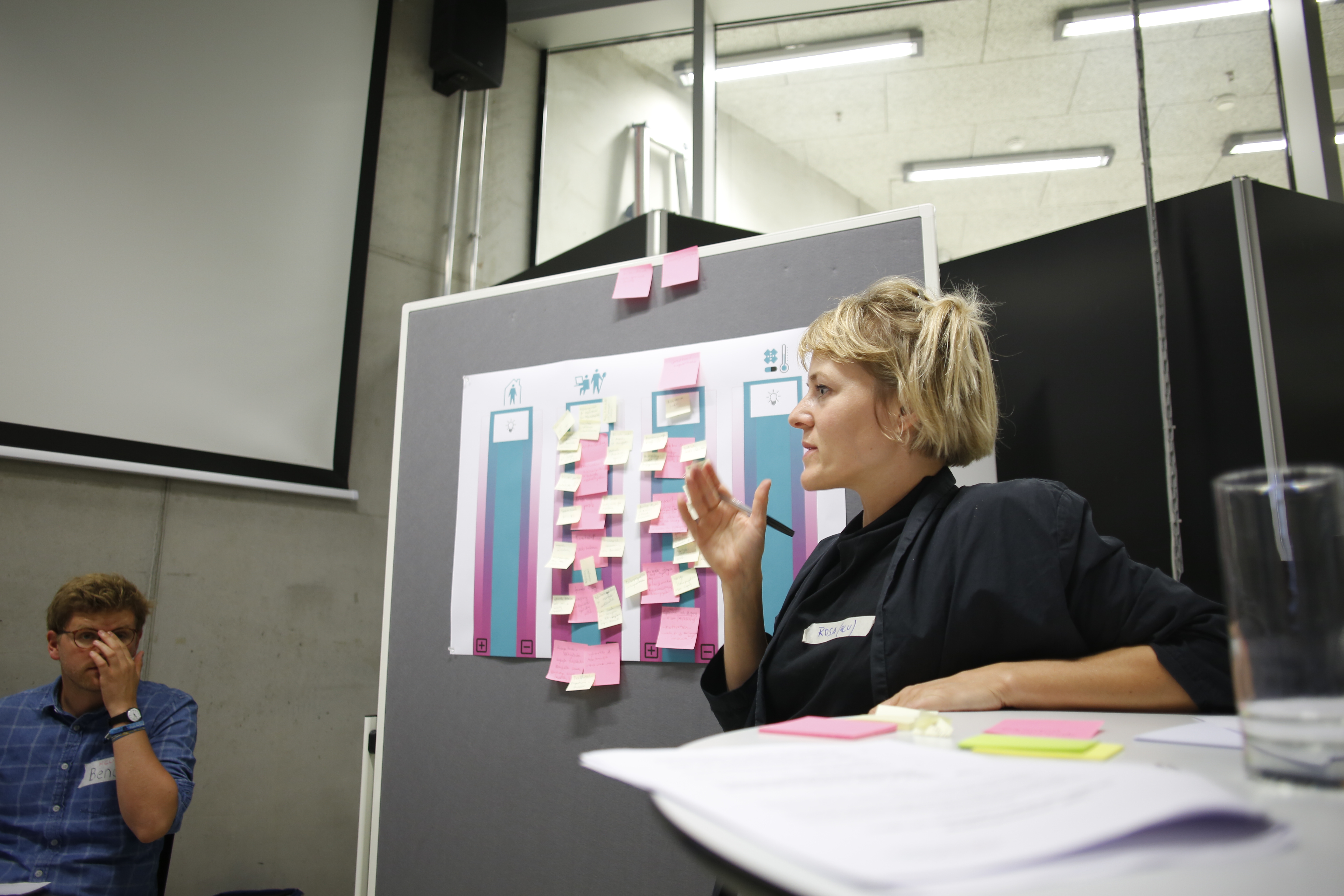 A researcher in front of a flipchart showing a user story mapping